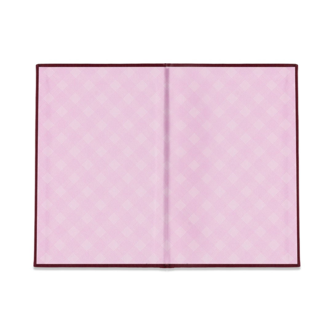 Pink gingham endpapers inside the burgundy covers