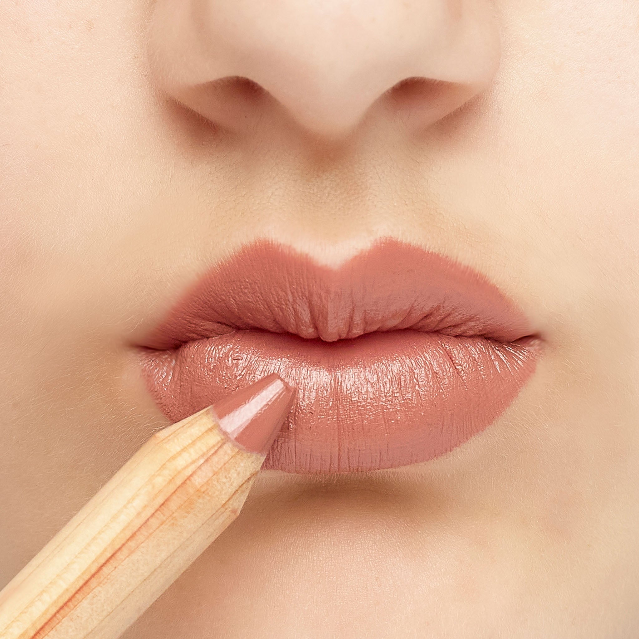 Lük Beautifood natural lipstick crayon in Caramel Kiss — worn on lips, shown with the pencil
