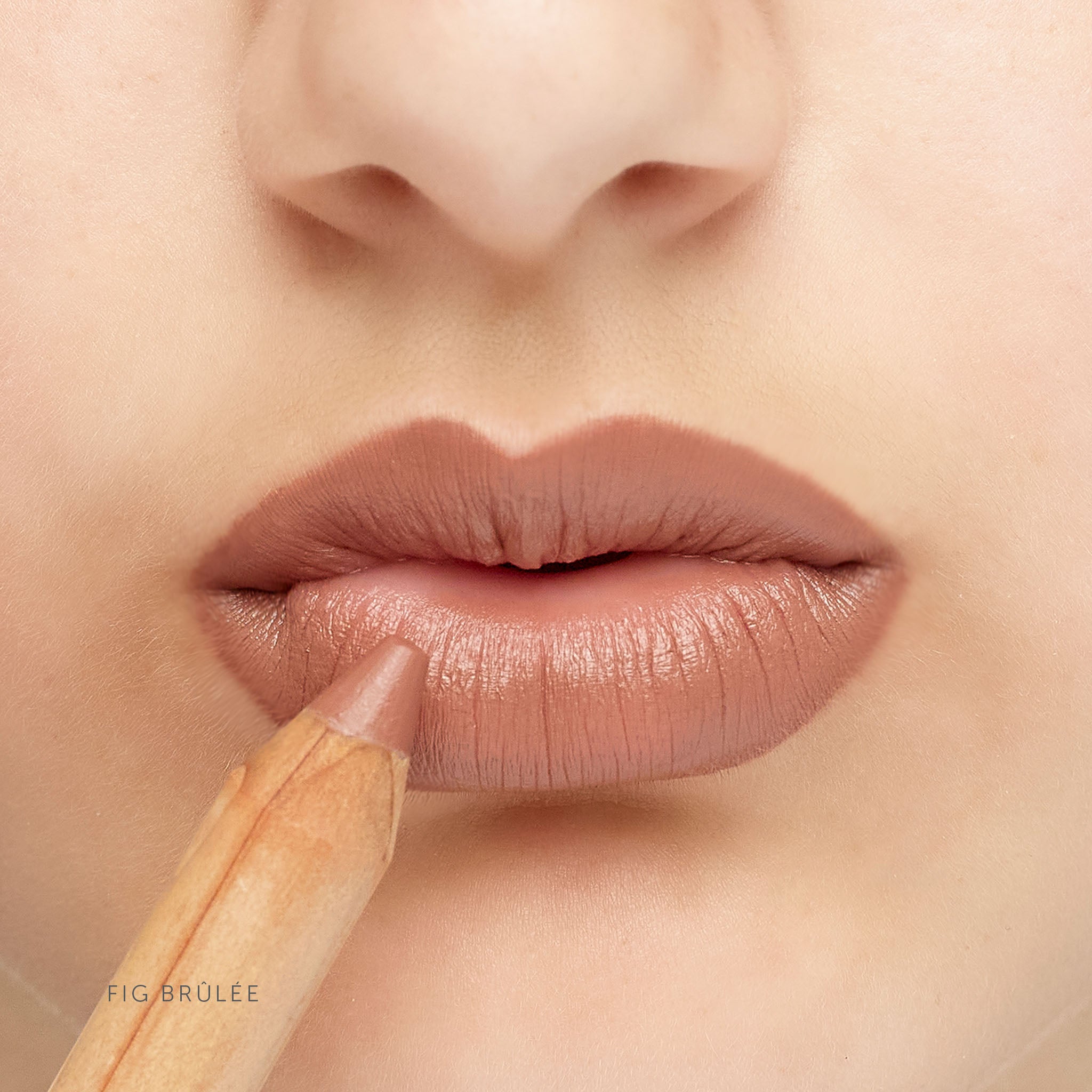 Lük Beautifood natural lipstick crayon in Fig Brûlée — worn on lips, shown with the pencil