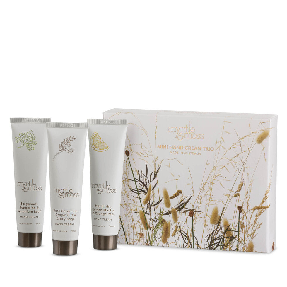 The three Wild Grasses mini hand cream tubes standing in front of their cream box.