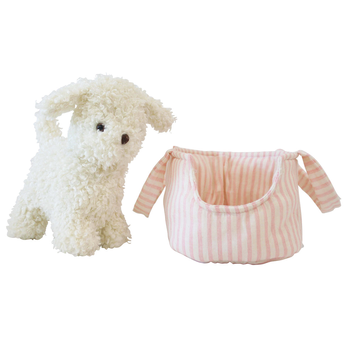 Fluffy cream Marshmallow puppy plush standing beside a pink striped fabric pet carrier