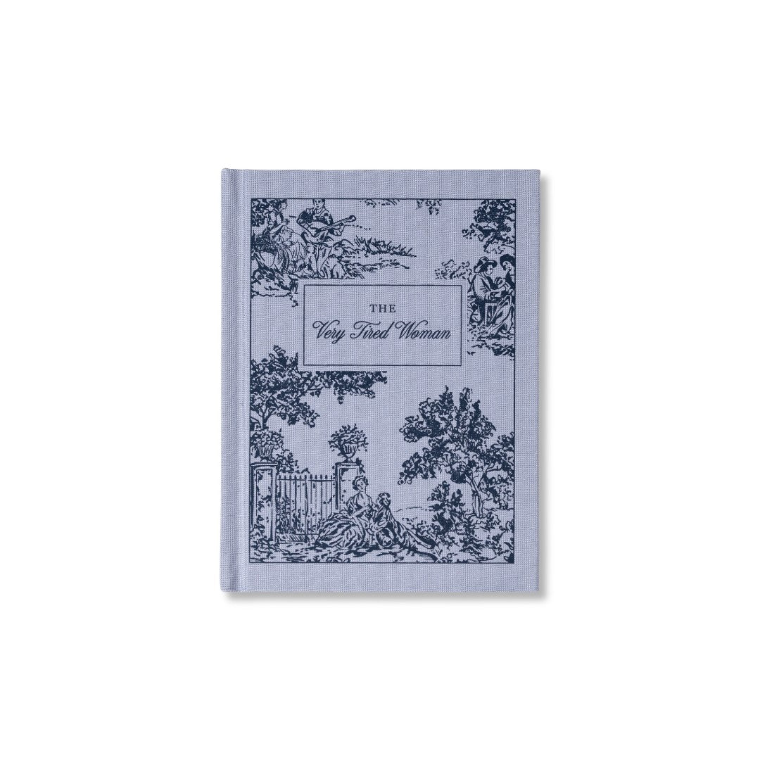 Pale blue-grey bookcloth notepad printed all over in navy toile, with The Very Tired Woman in a panel at the centre