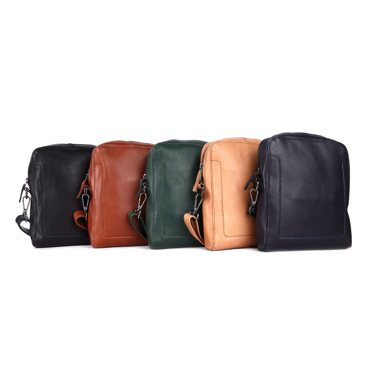 Sling bags lined up in black, cognac, green, nude and navy