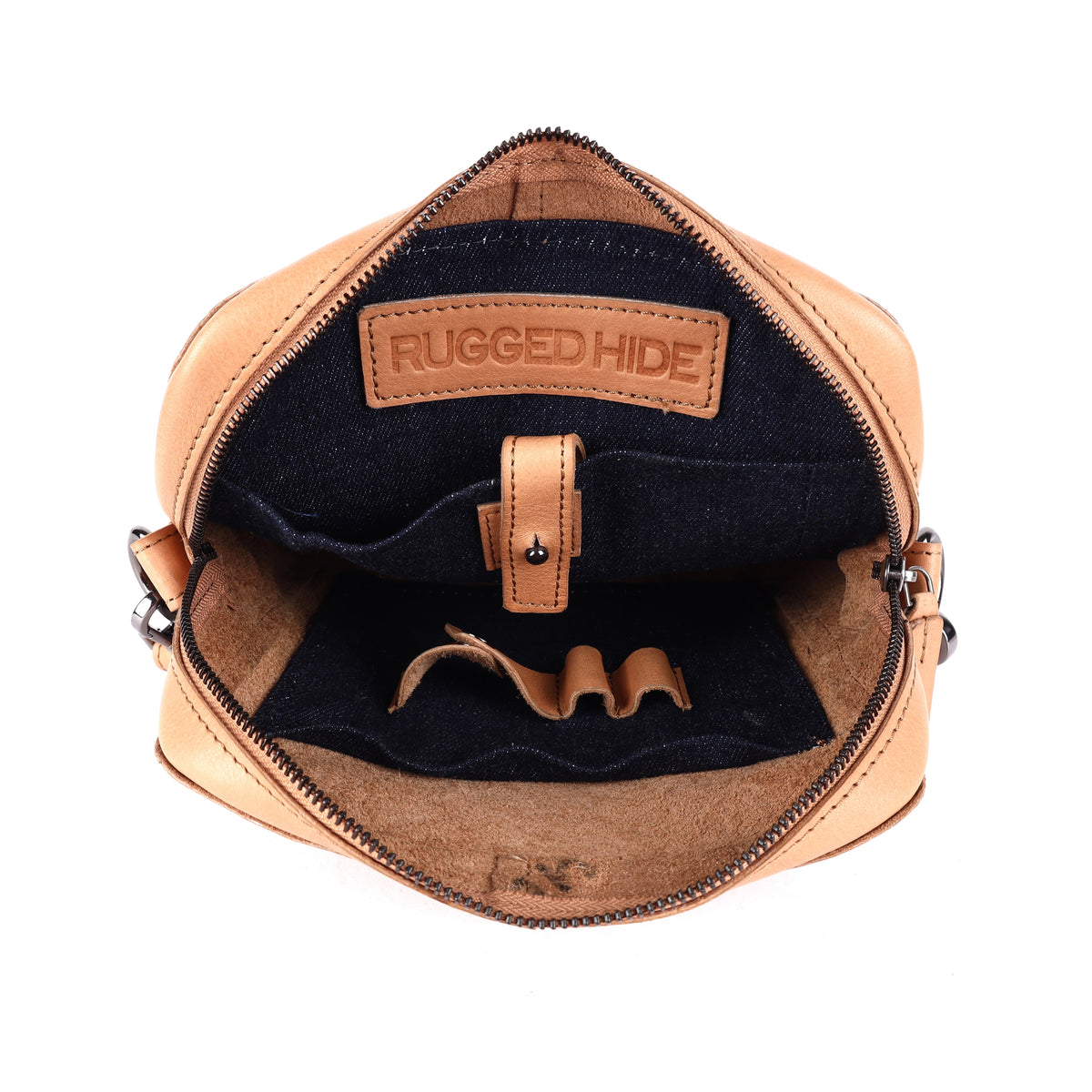 The nude bag open, showing the dark navy lining, the tablet sleeve tab and a stamped leather tab