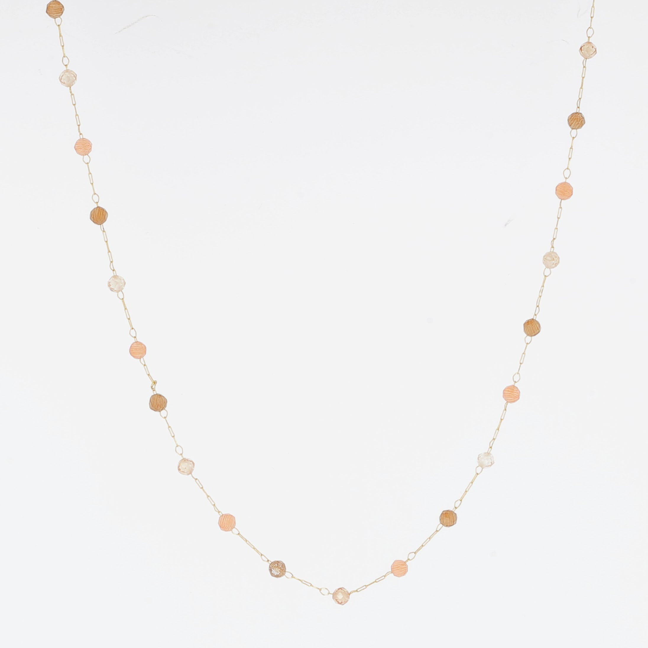 Fine gold chain necklace with small peach and sand coloured stones spaced along it