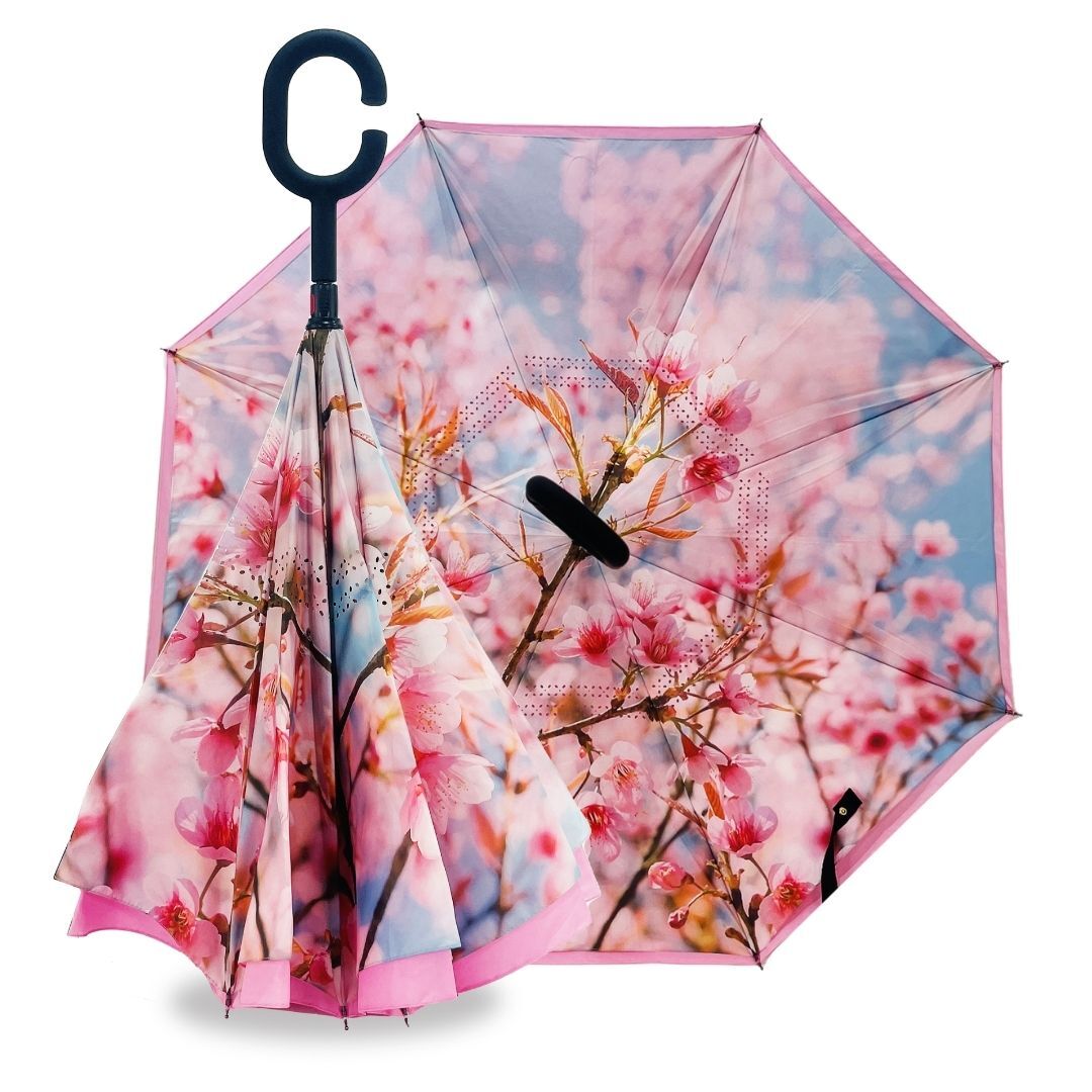 Reverse umbrella in Sky Blossom design with pink cherry blossoms against blue sky