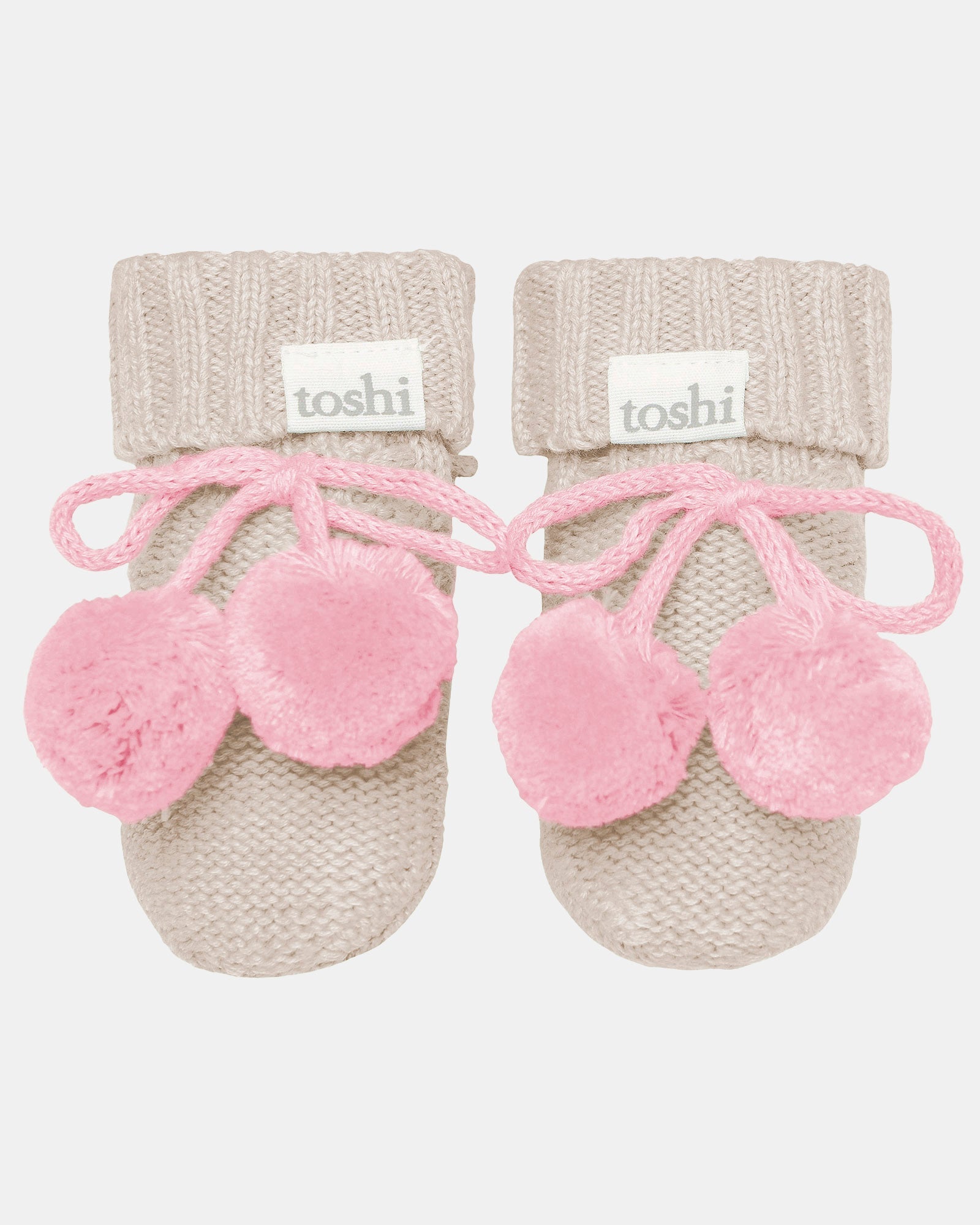 Toshi Organic Booties Bobby in oatmeal knit with soft pink pompoms and tie fastening