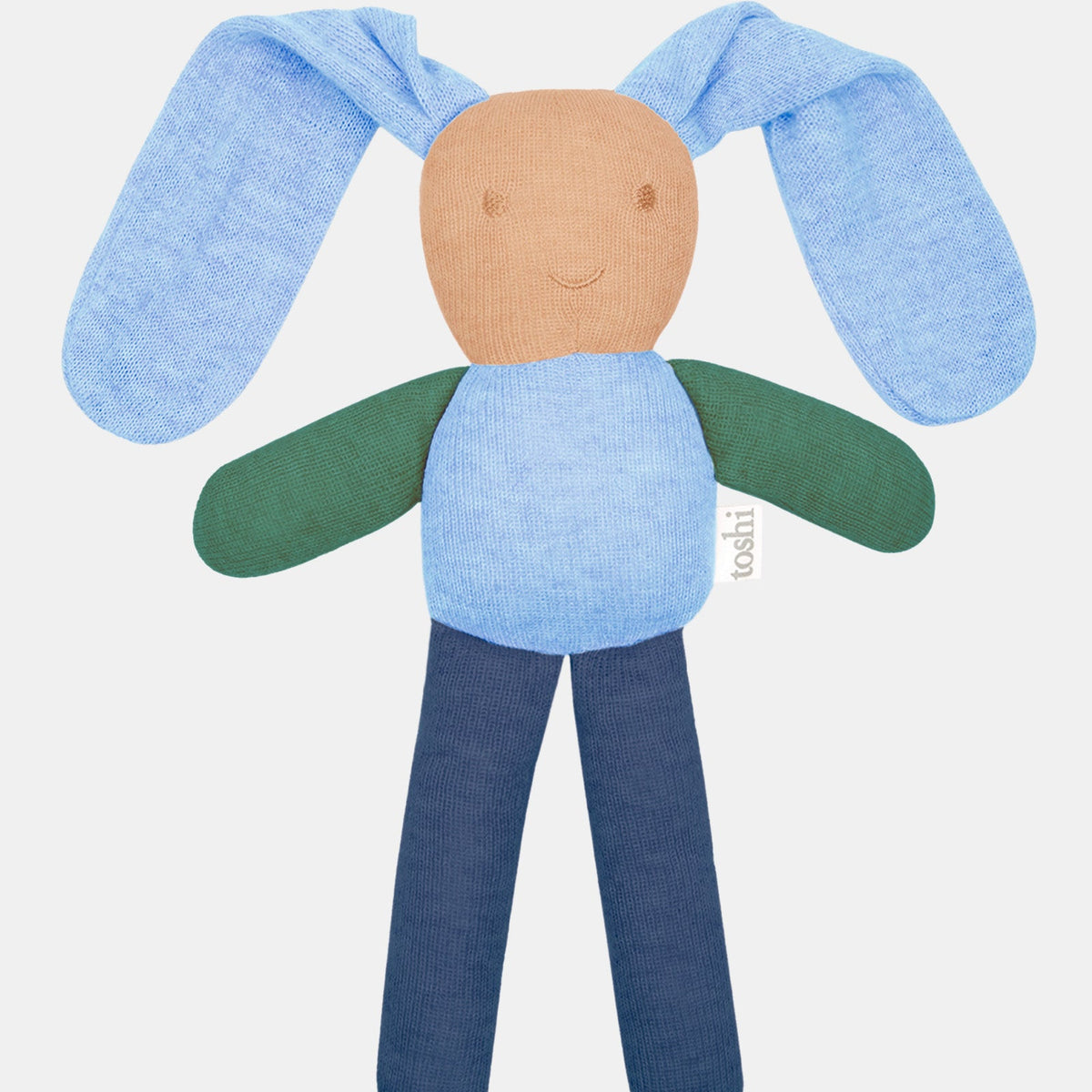 Toshi Bunny Bobby knitted comforter in bluebell — long floppy pale blue ears, a tan face with an embroidered smile, green arms and navy legs