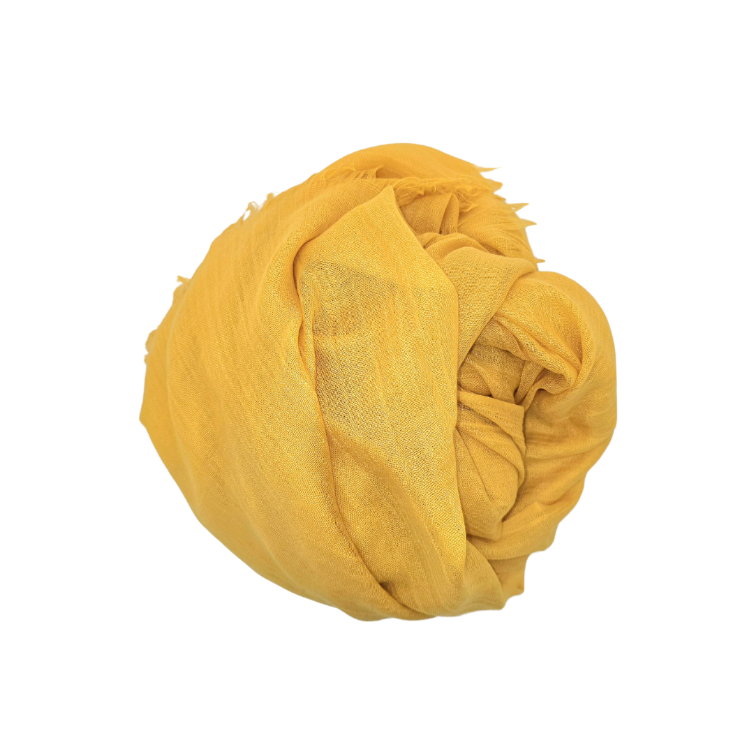Beauty in Bamboo scarf in Turmeric, a golden yellow, bundled into soft folds