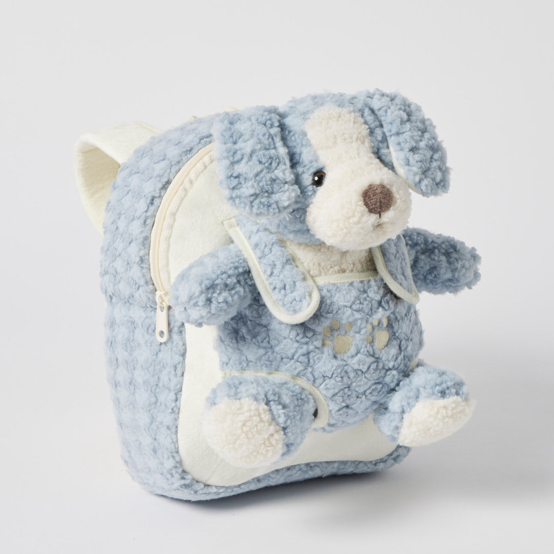 The puppy tucked into the backpack's front pocket, its head, floppy ears and paws peeping out