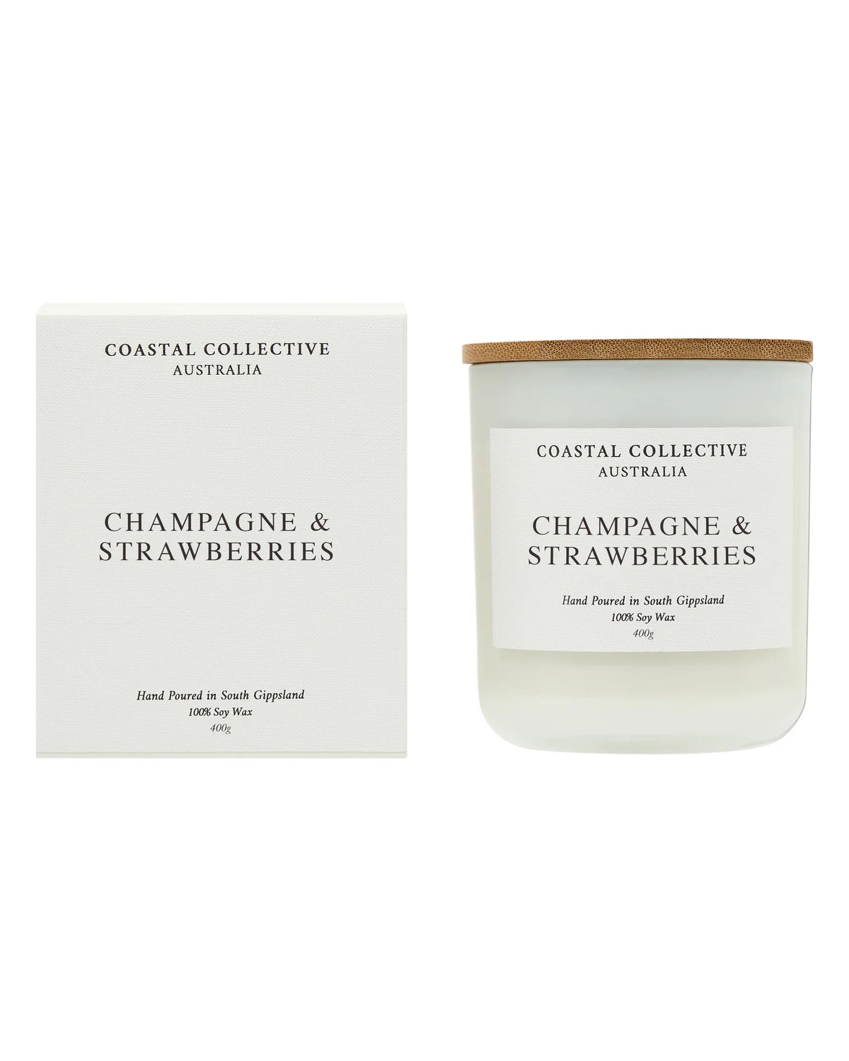 The Champagne & Strawberries candle standing beside its plain cream gift box.