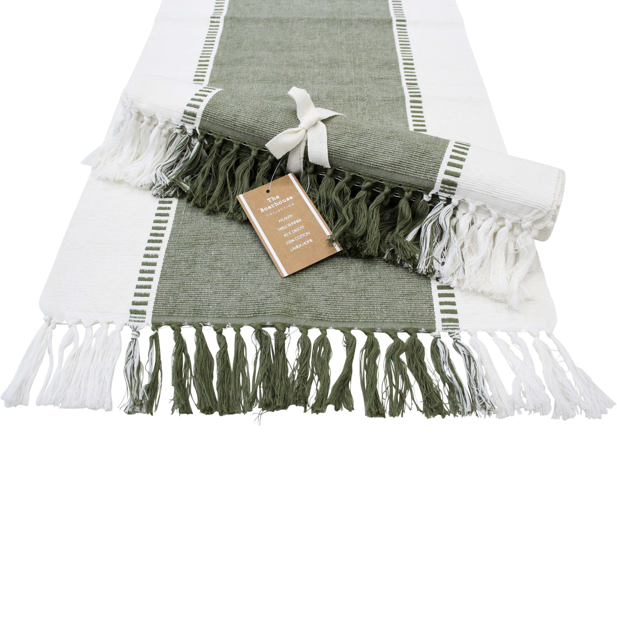 Olive green and white table runner laid flat with olive and white tassels, a second runner rolled and tied with a ribbon on top