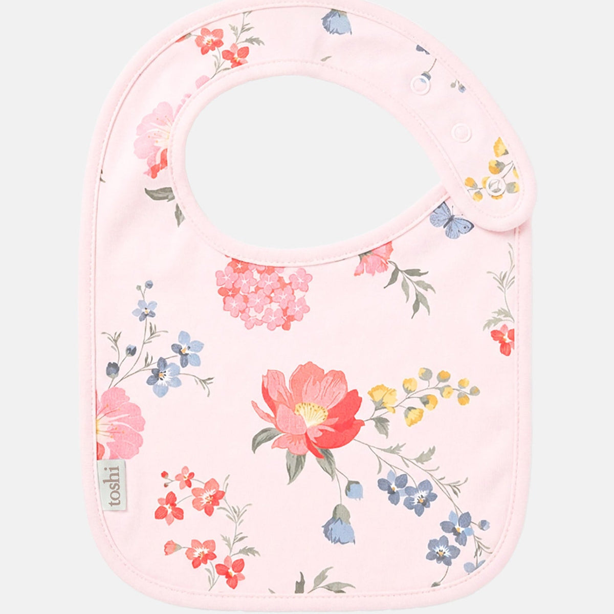 Toshi Arcadia Wild Garden baby bib in pale pink cotton printed with coral, pink and blue florals with butterflies