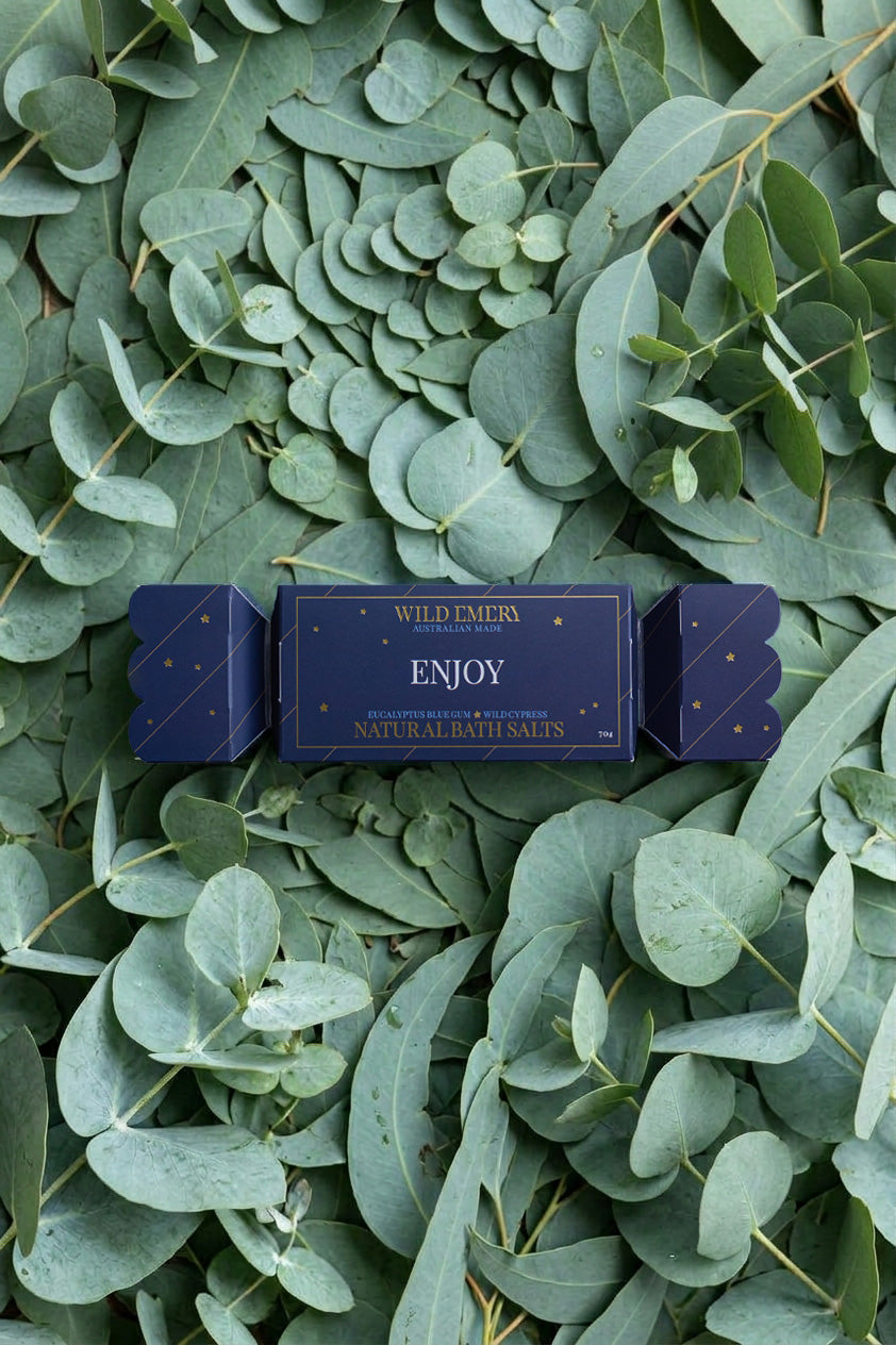 The Enjoy bon bon on a bed of eucalyptus leaves.
