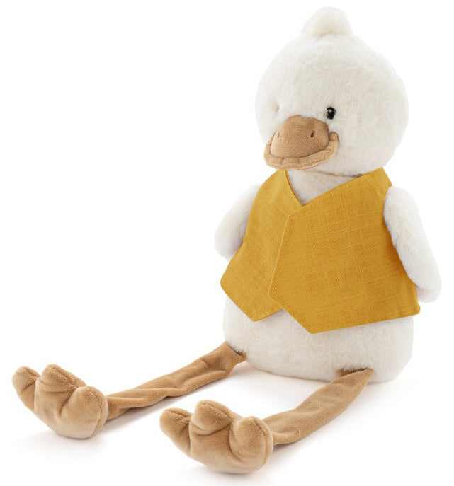 Cream plush duck with long dangly legs, sitting in a plain mustard linen bib.