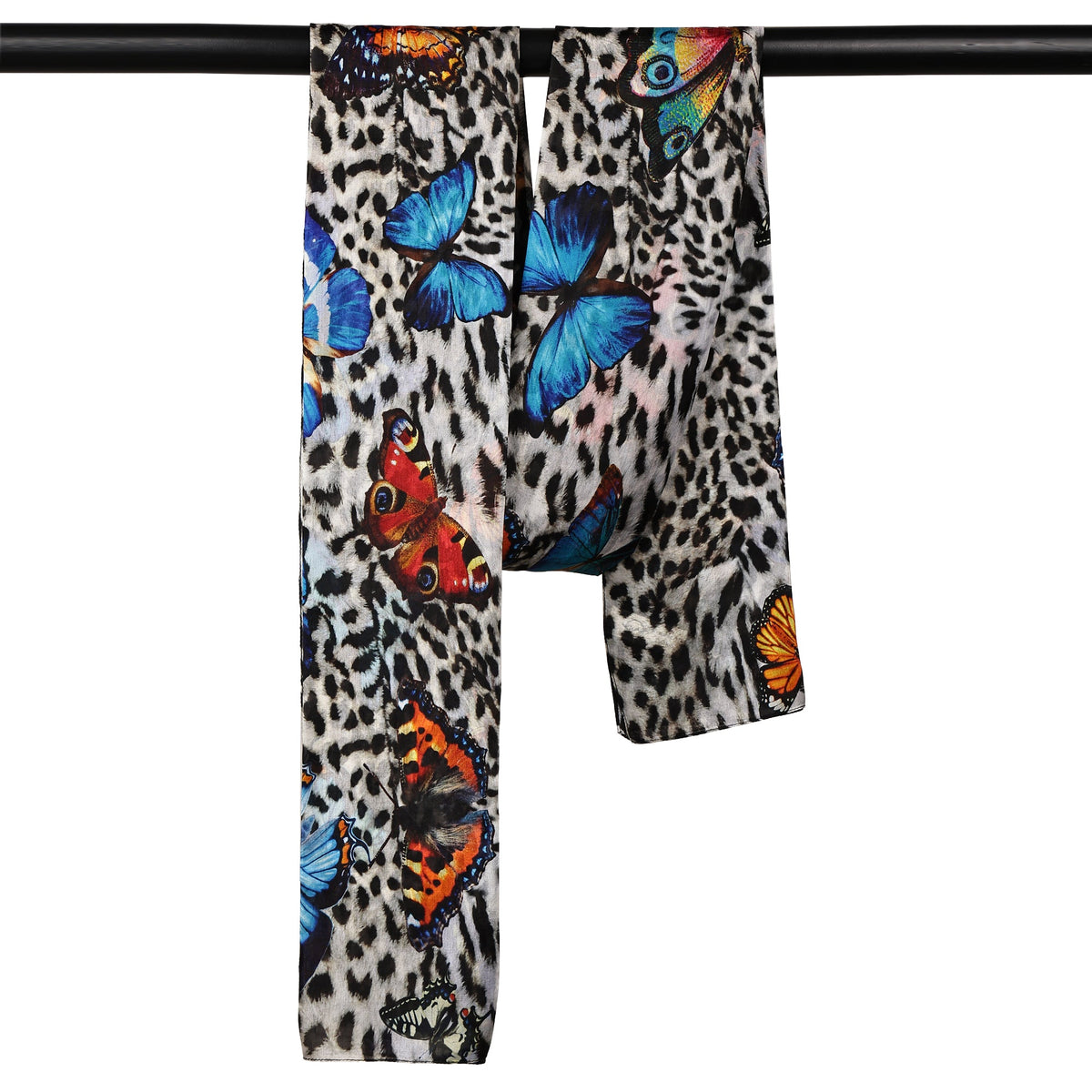The Butterfly Jungle scarf hanging over a rail, showing butterflies along the leopard print