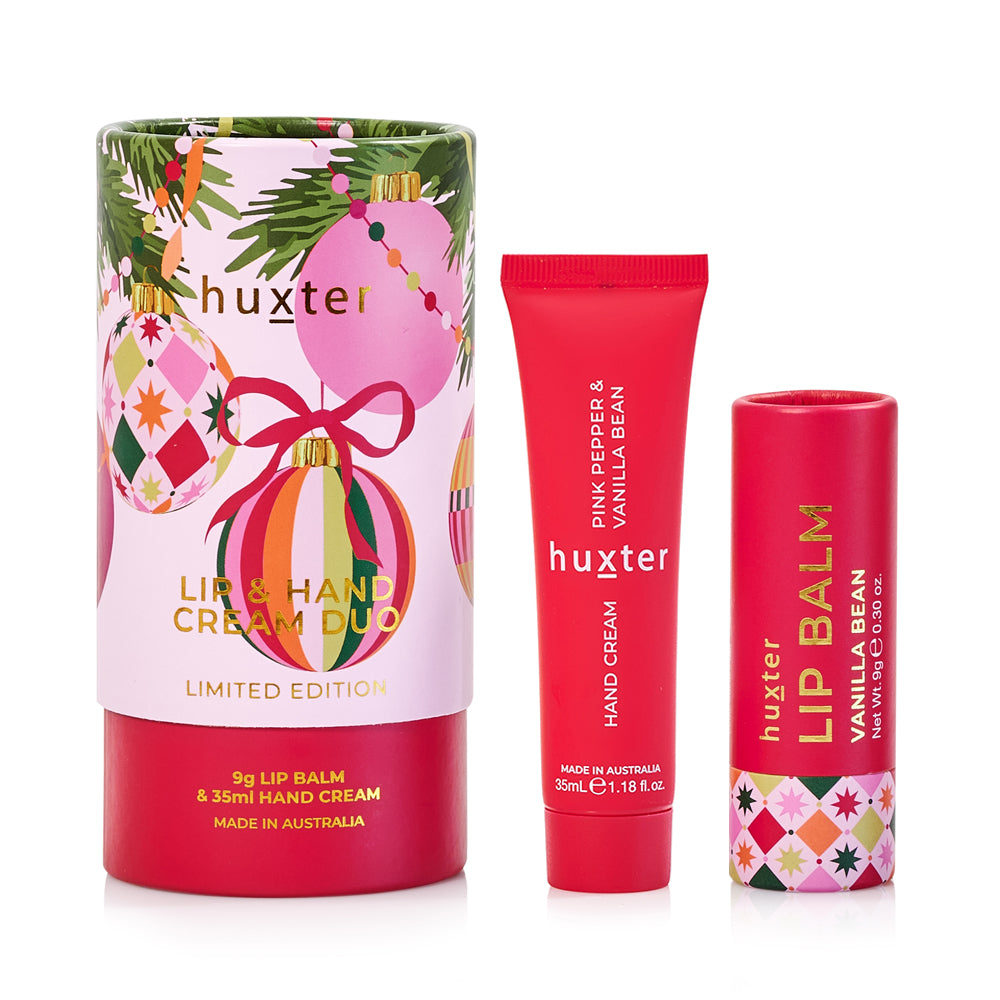 Huxter Lip & Hand Cream Duo round gift tube with Christmas baubles, beside a red hand cream tube and a red Vanilla Bean lip balm.