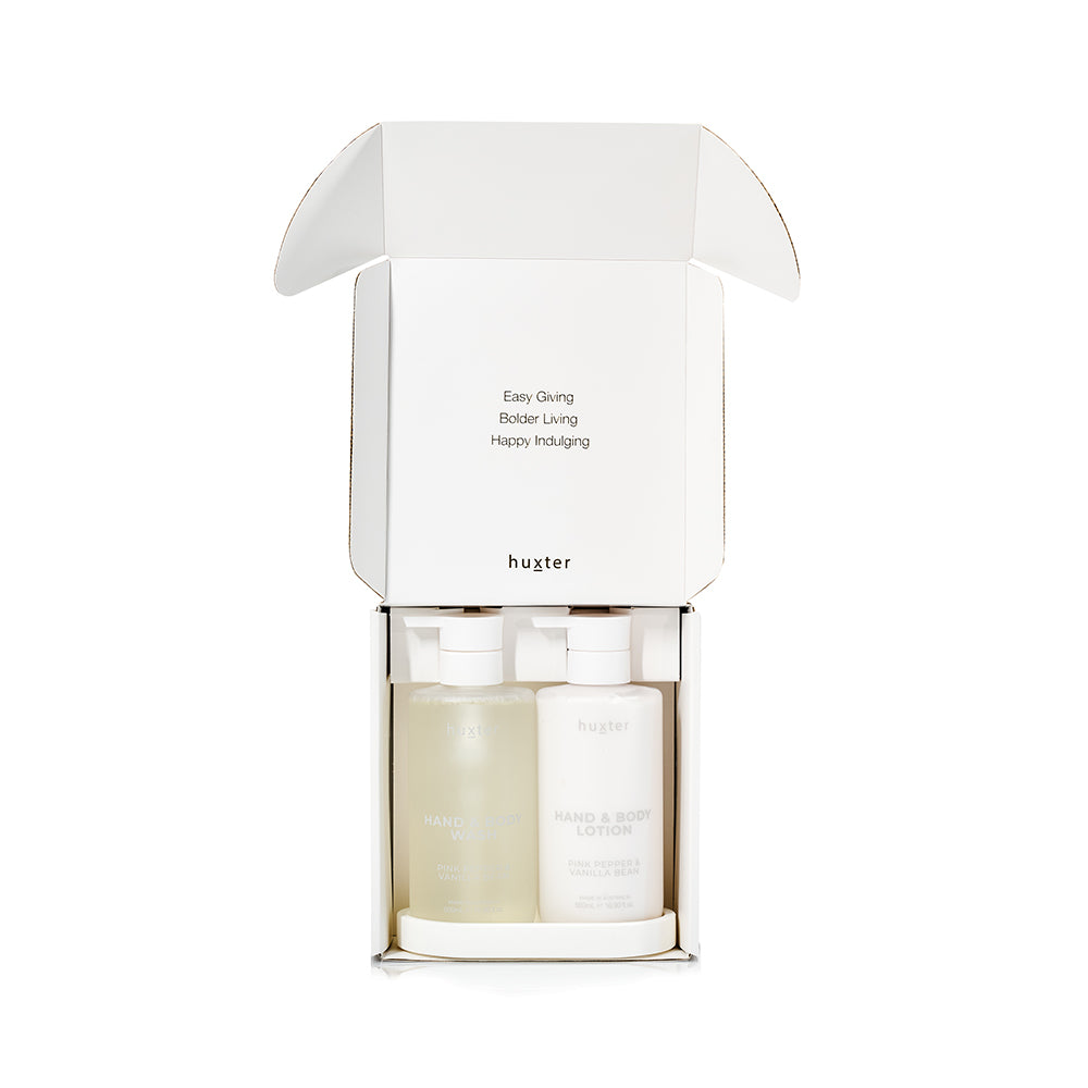 The Huxter gift box opened, showing the wash and lotion bottles on their tray inside.