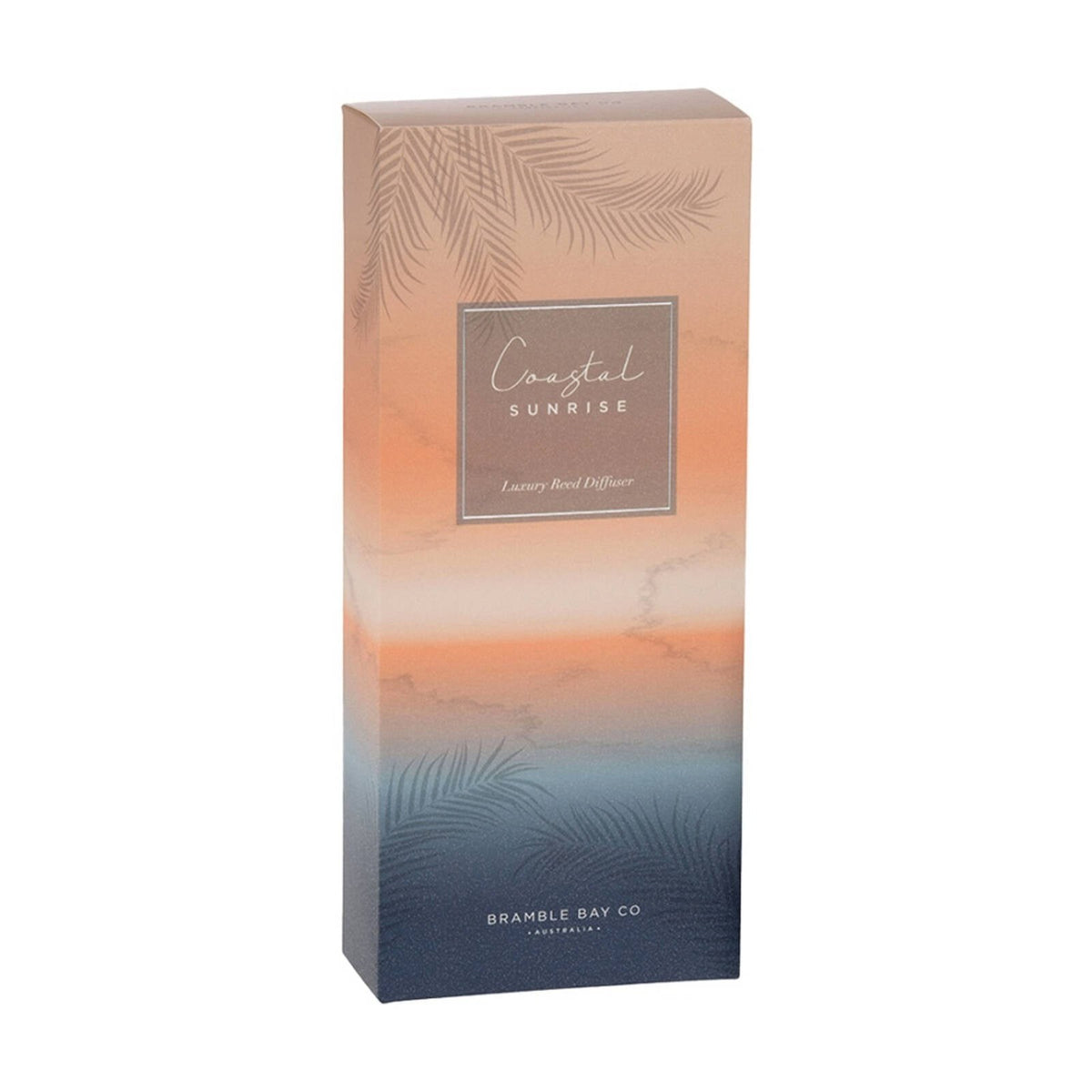 The Coastal Sunrise gift box on its own, peach fading to navy with a palm print.