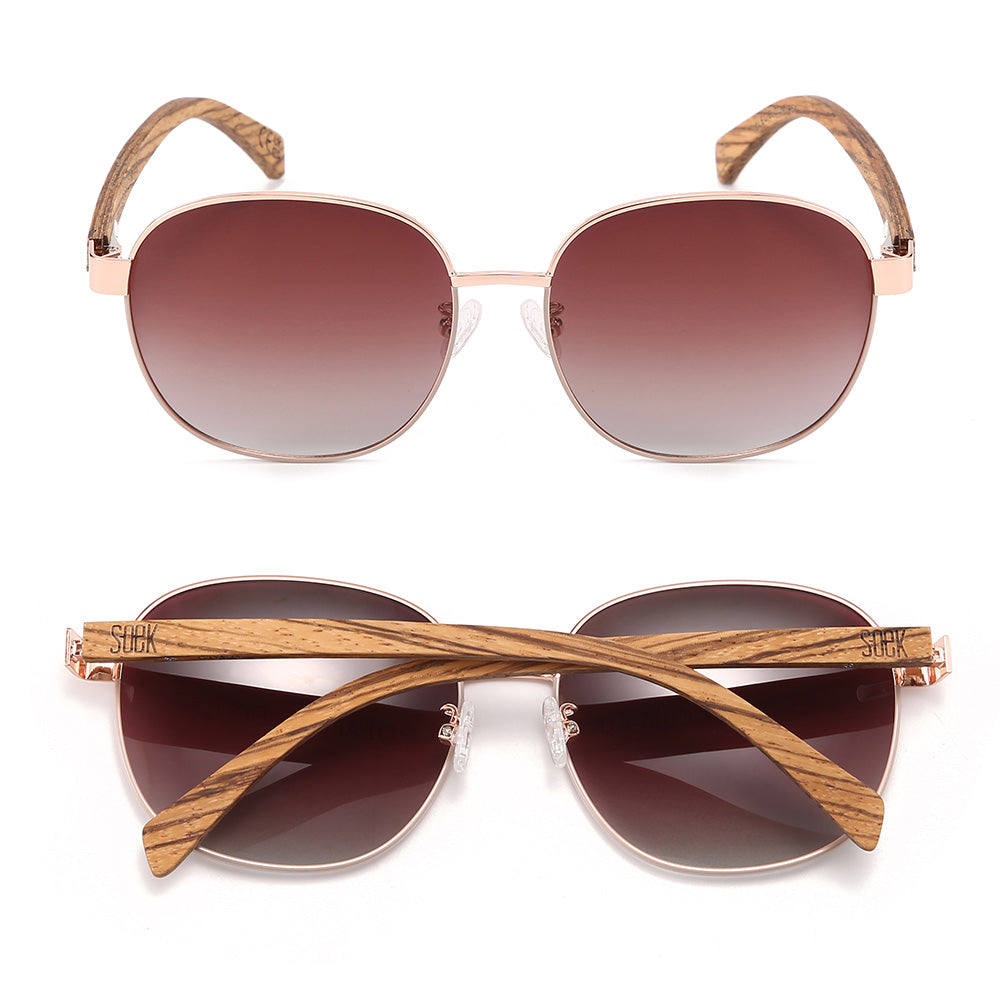 Cleo Bloom sunglasses front-on and folded from above, with brown gradient lenses and striped walnut arms