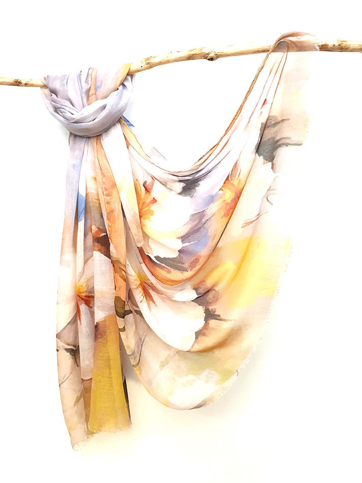 Apricot Watercolour cotton viscose scarf knotted over a branch, watercolour blooms in cream, apricot and yellow