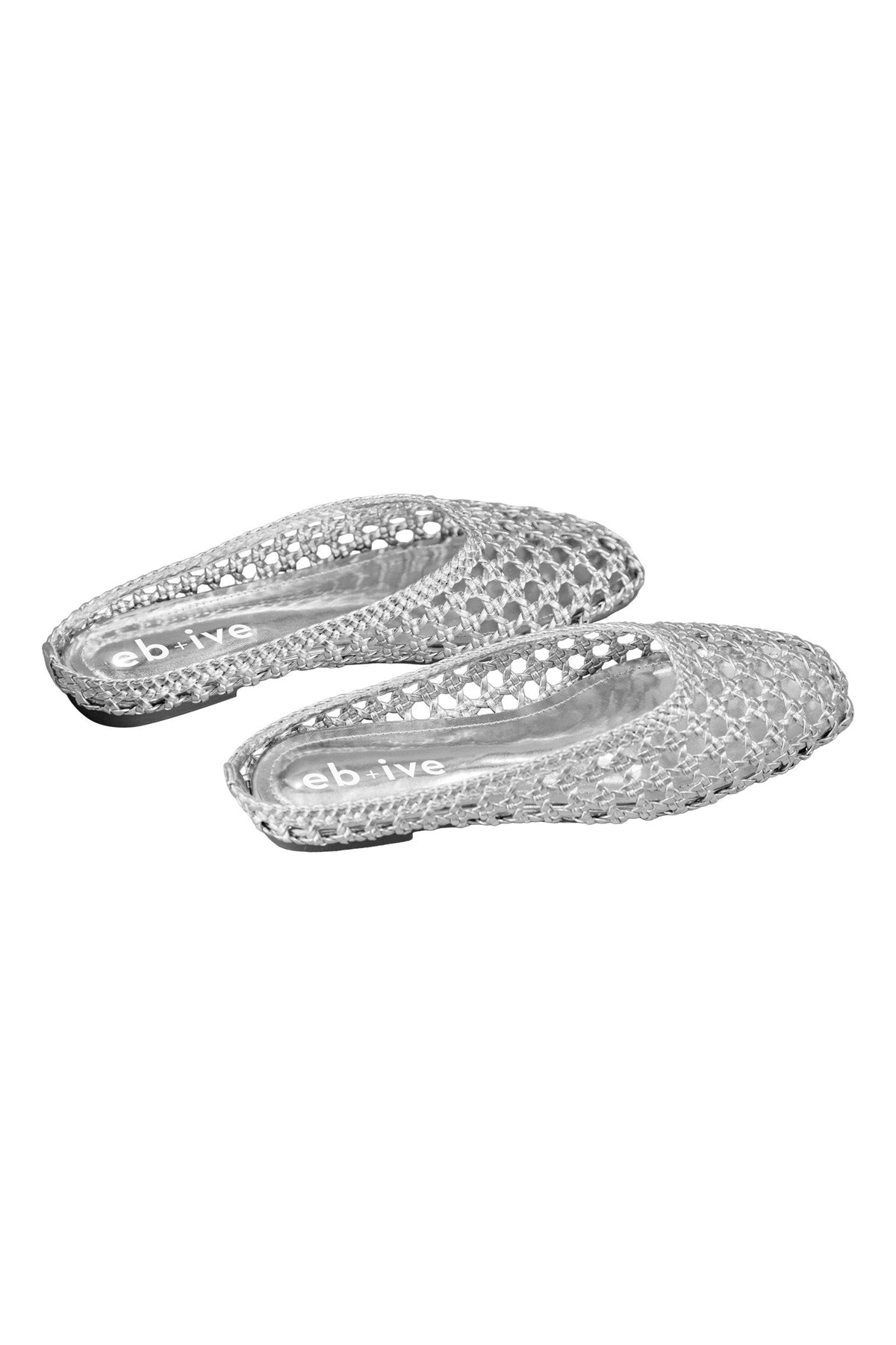 Pair of silver Dusk Slides at an angle, showing the open backs and flat soles