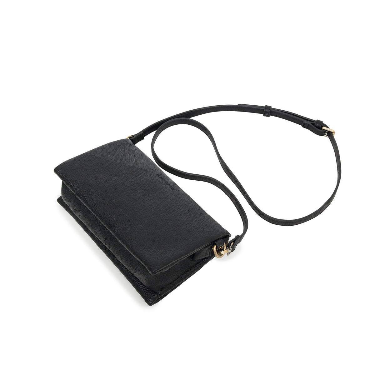 The black bag lying at an angle with the slim strap looped behind.