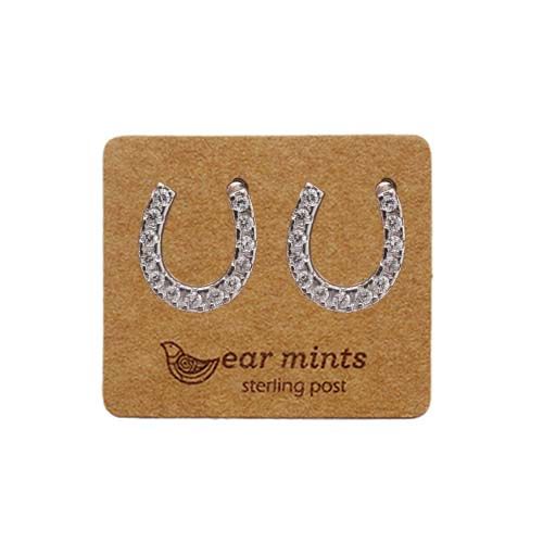Pair of silver-tone horseshoe stud earrings set with clear cubic zirconia, on an Ear Mints card.