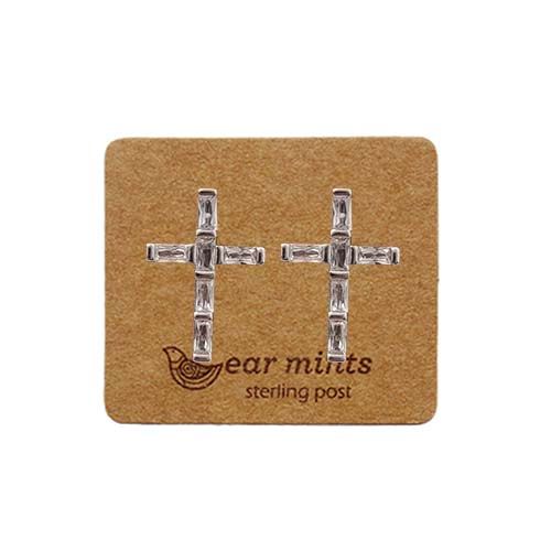 Silver-tone cubic zirconia cross stud earrings with baguette stones, on an Ear Mints card
