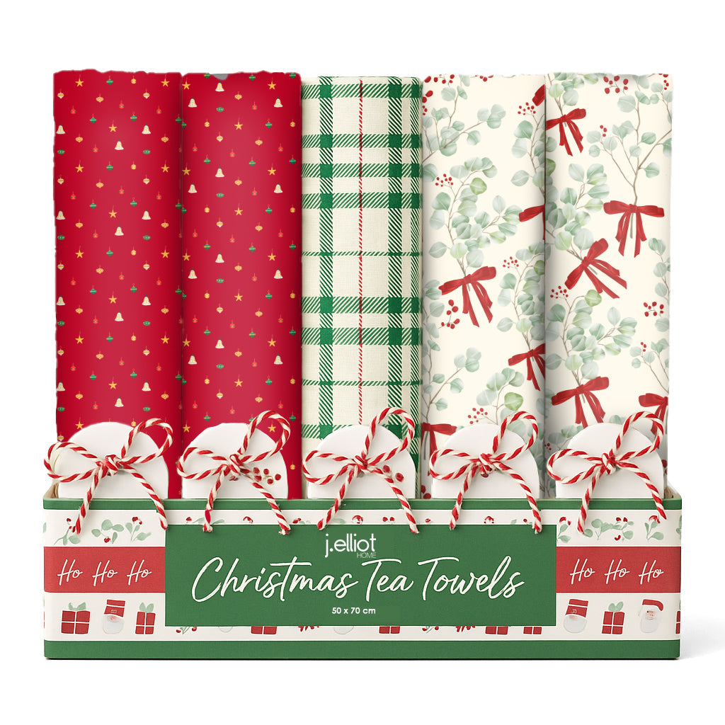 Festive Collection display box of folded Christmas tea towels in red bauble, green plaid and eucalyptus bow prints, each tied with red and white twine