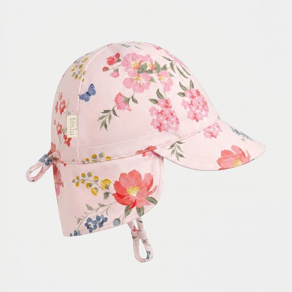 Toshi Arcadia Wild Garden flap cap in pale pink cotton with a floral and butterfly print and a neck flap