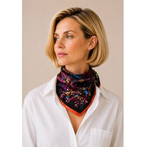 Model in a white shirt wearing the Forgotten Temple Pink silk scarf knotted at the neck