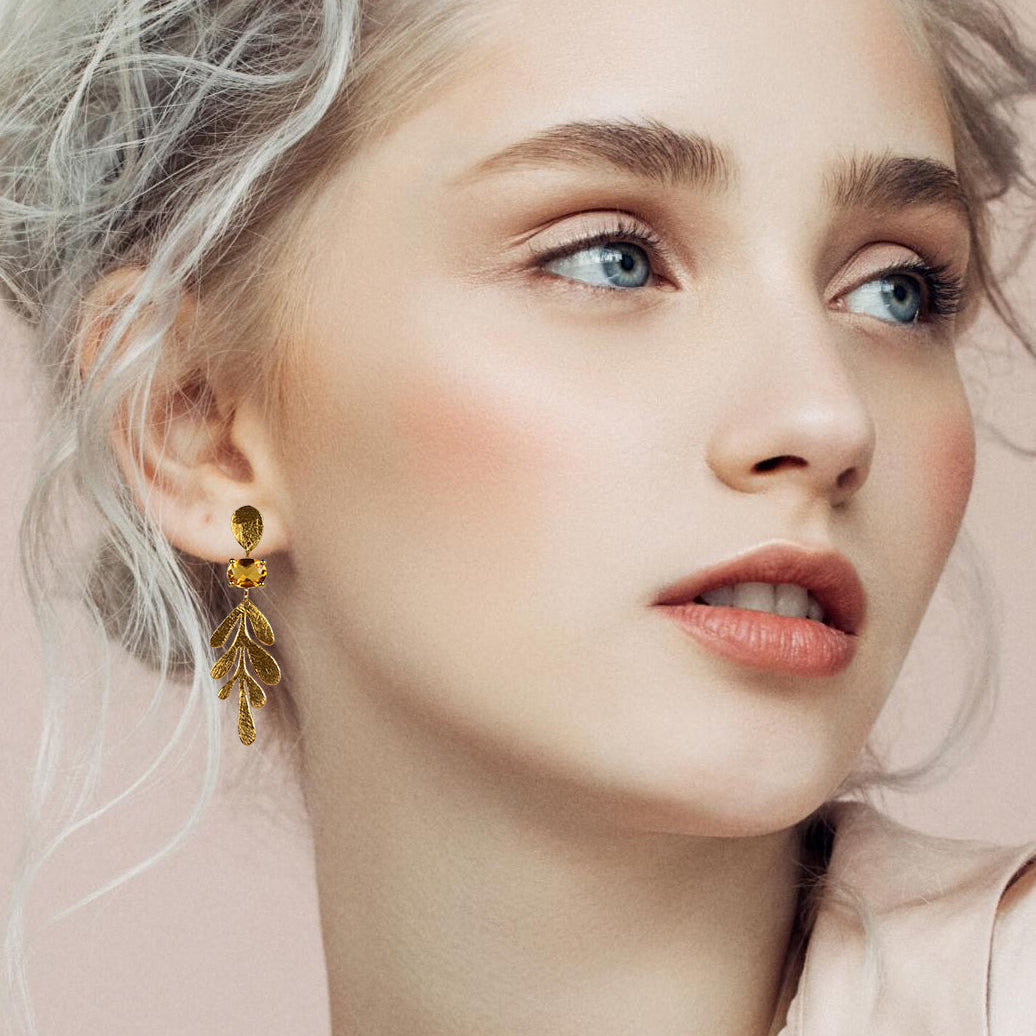 Model wearing a Euro Gold leaf drop earring, side profile