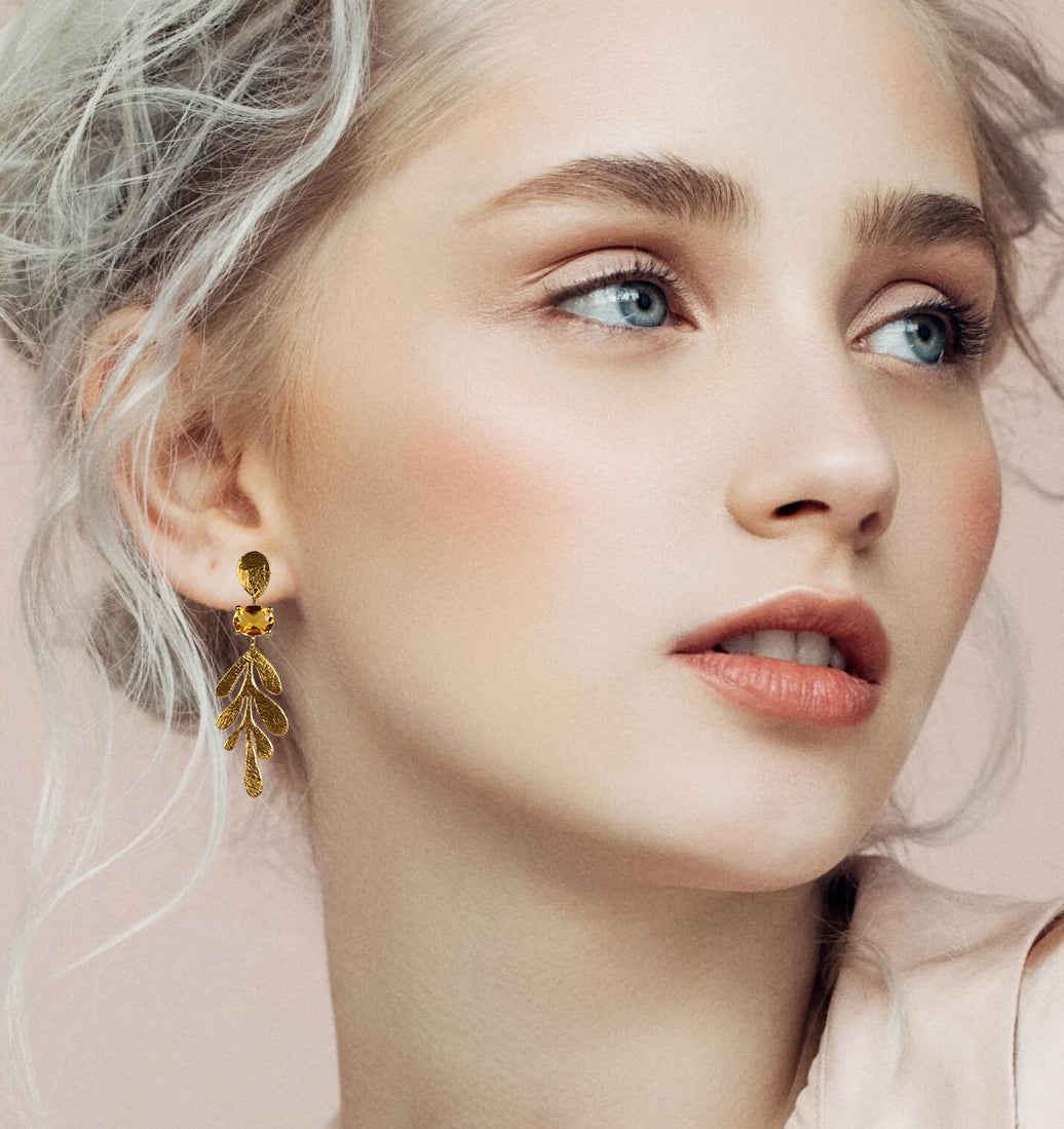 Model wearing a Euro Gold leaf drop earring, side profile