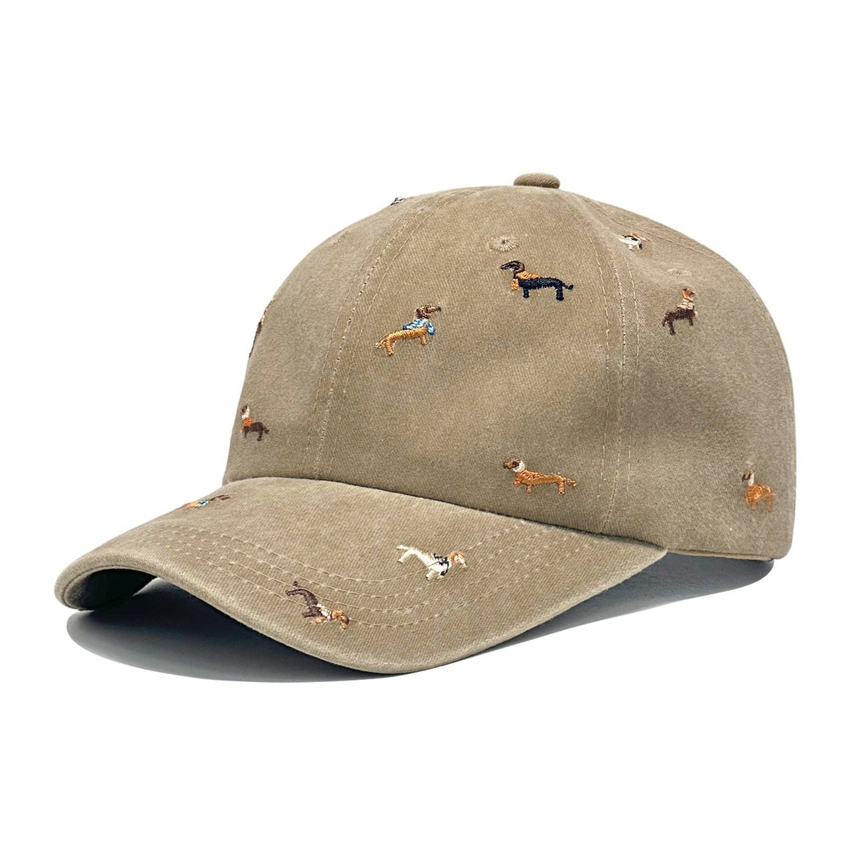 Khaki-beige brushed cotton cap embroidered with small dachshunds in coloured coats, shown from the front.