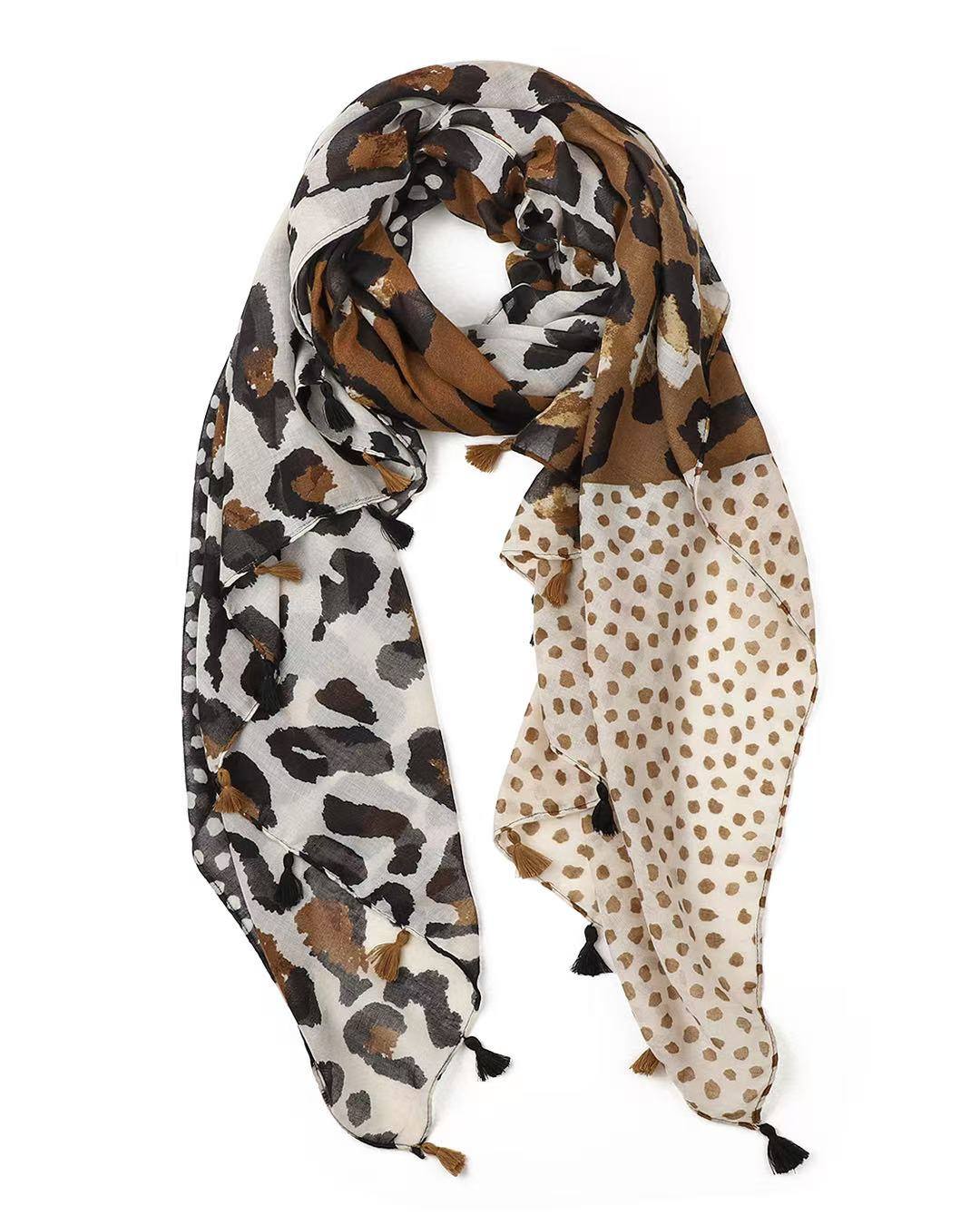 Lightweight cream scarf in a split leopard-print and polka-dot design in tan, brown and black, looped to show the tassels.
