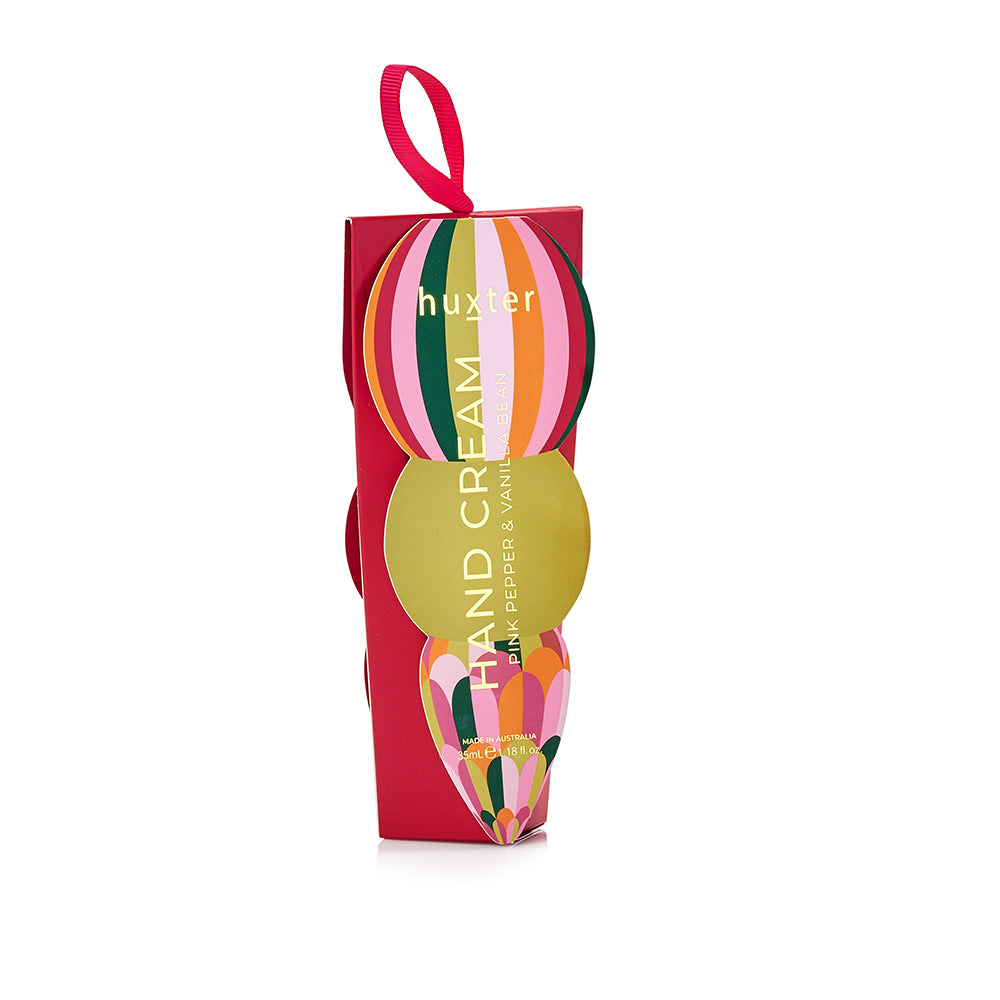 Red Huxter hand cream box with a striped Christmas bauble on the front and a pink ribbon loop.