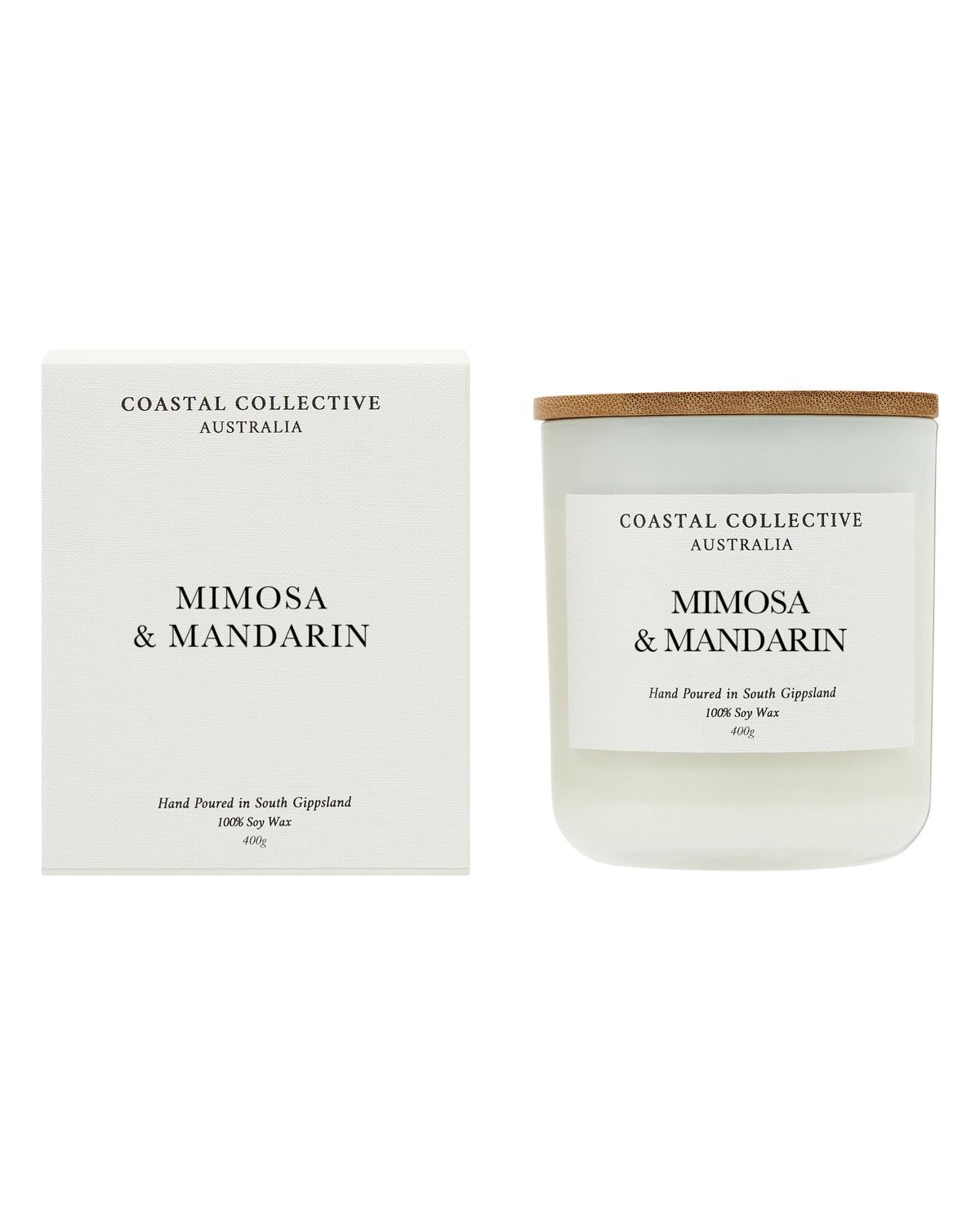 The Mimosa & Mandarin candle standing beside its printed white gift box.