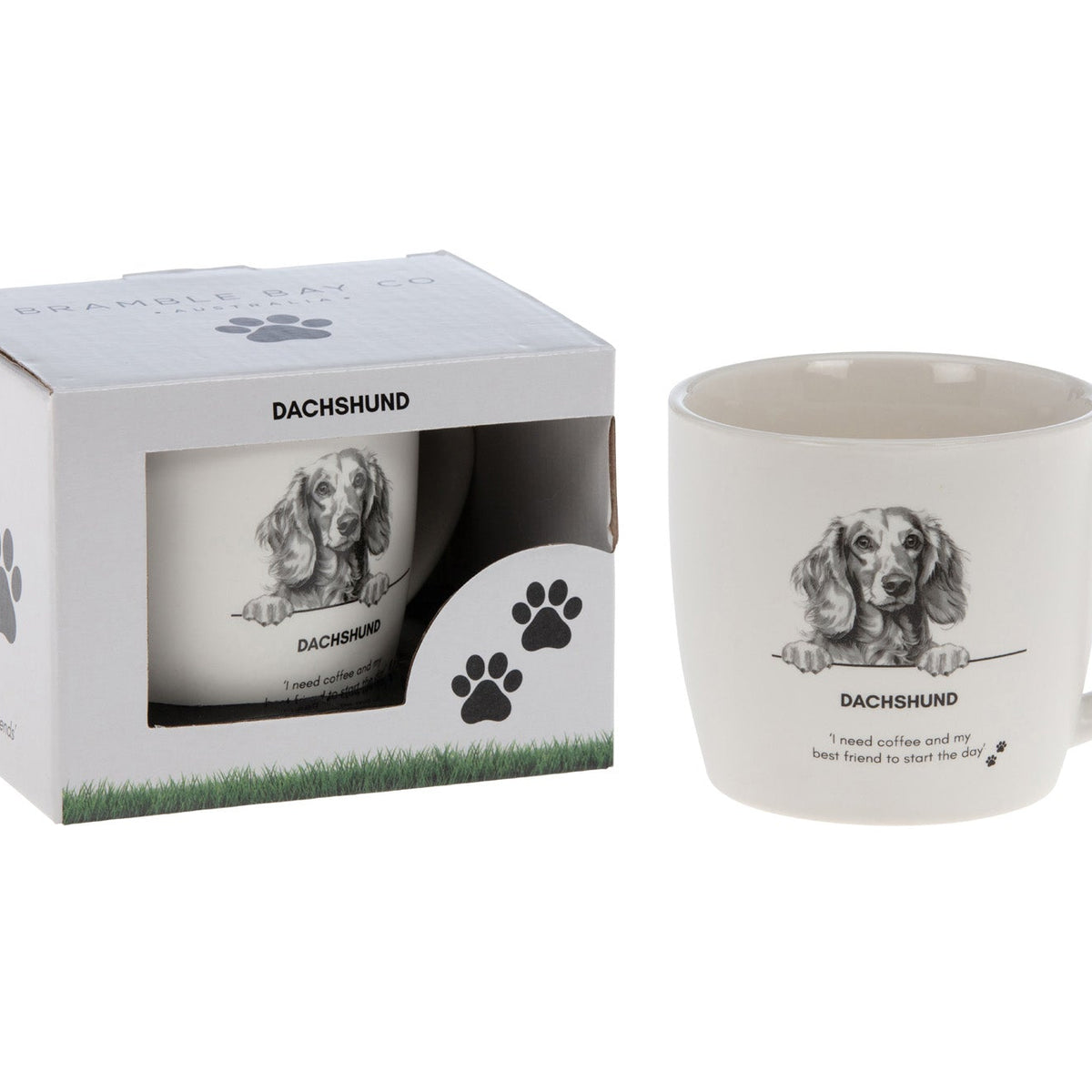White mug with a sketched dachshund portrait and the words Dachshund and I need coffee and my best friend to start the day, beside its paw-print gift box