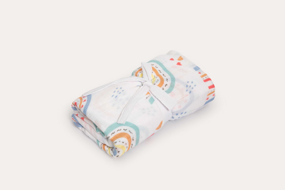 The Rainbow muslin wrap rolled and tied with white cotton tape.