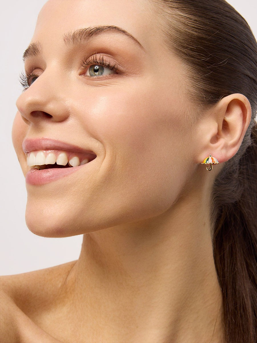A rainbow umbrella stud worn on the ear.
