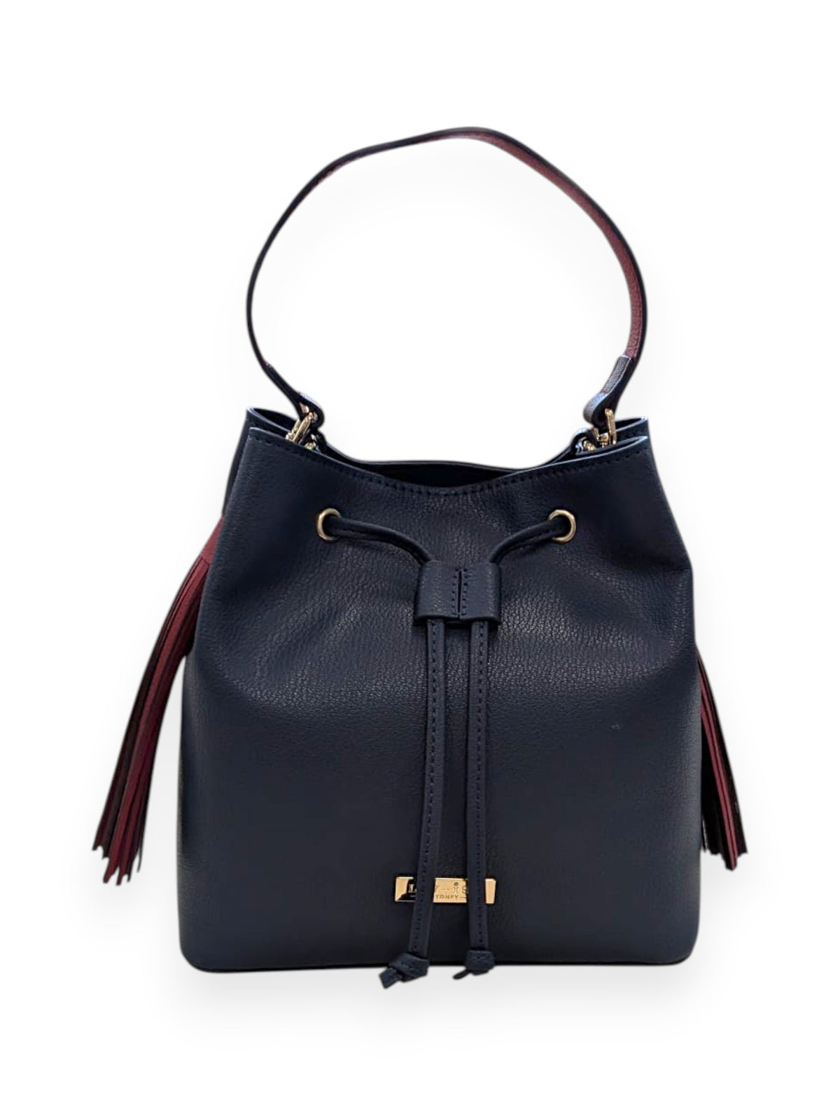 Front of the navy Ruby bucket bag with its drawstring tie, gold-tone logo plate and red side tassels