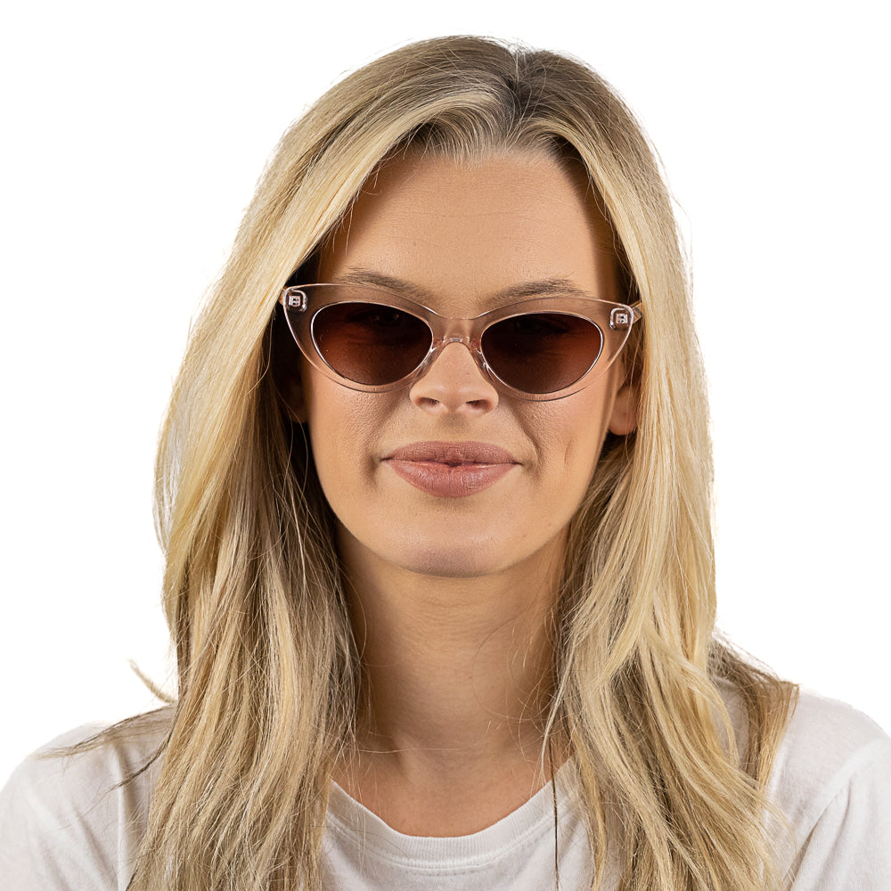 A woman with long blonde hair looking at the camera in the Savannah Blush Pink sunglasses