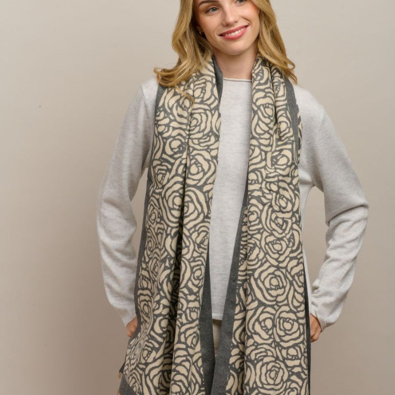 Model wearing the grey Wild Rose scarf draped over a grey jumper