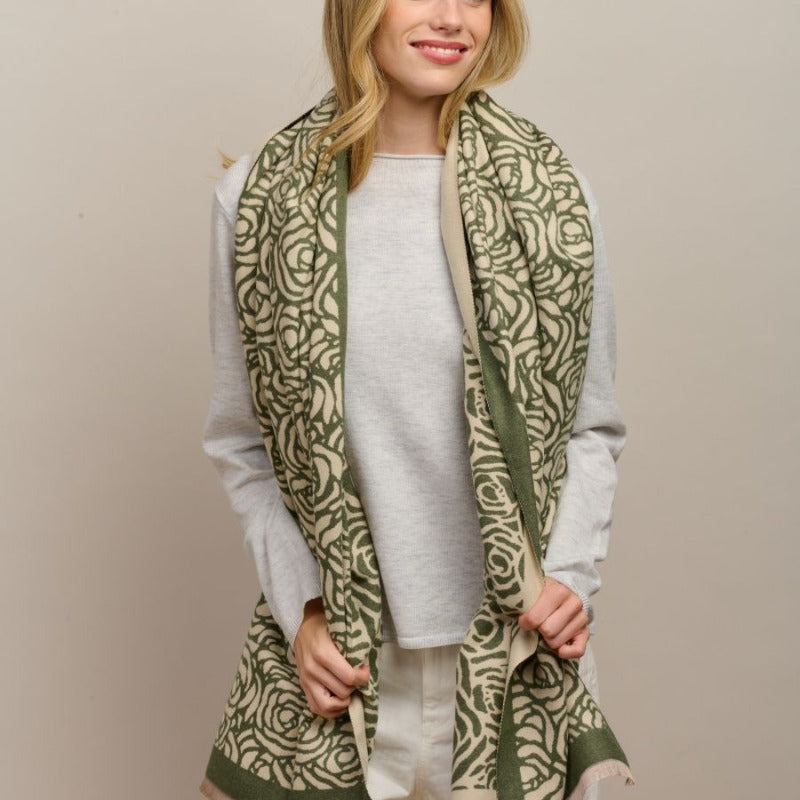 Model with the green Wild Rose scarf over a light grey jumper