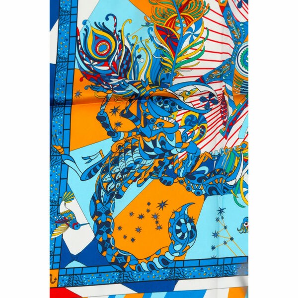 Close-up of the Astro Scorpio silk scarf - an ornately patterned blue scorpion with peacock feathers, stars and orange panels