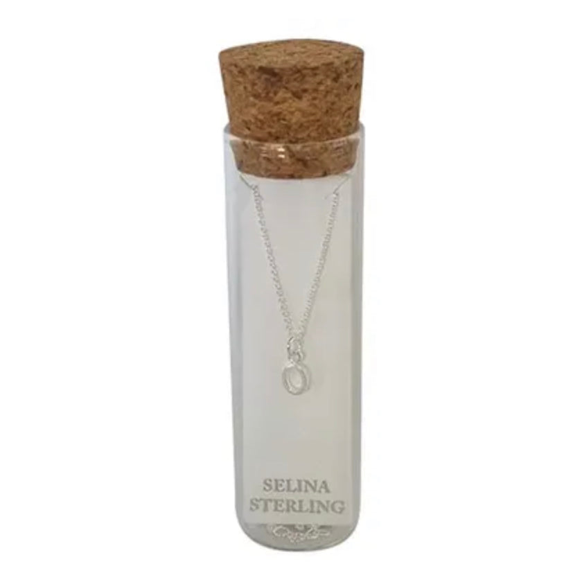 Selina sterling silver letter O initial necklace in its cork-topped glass gift tube
