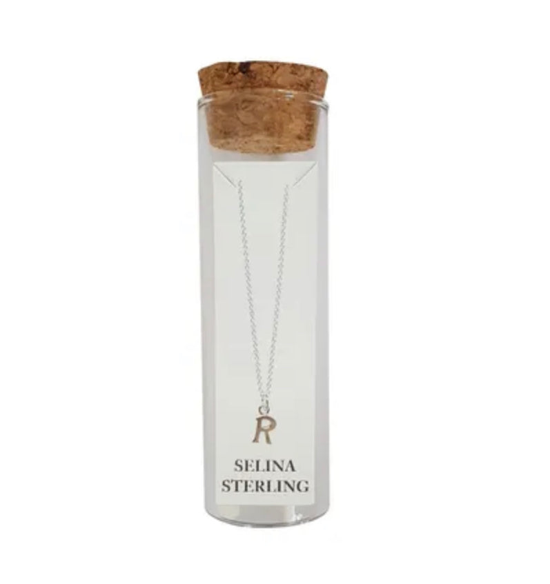 Selina sterling silver letter R initial necklace in its cork-topped glass gift tube
