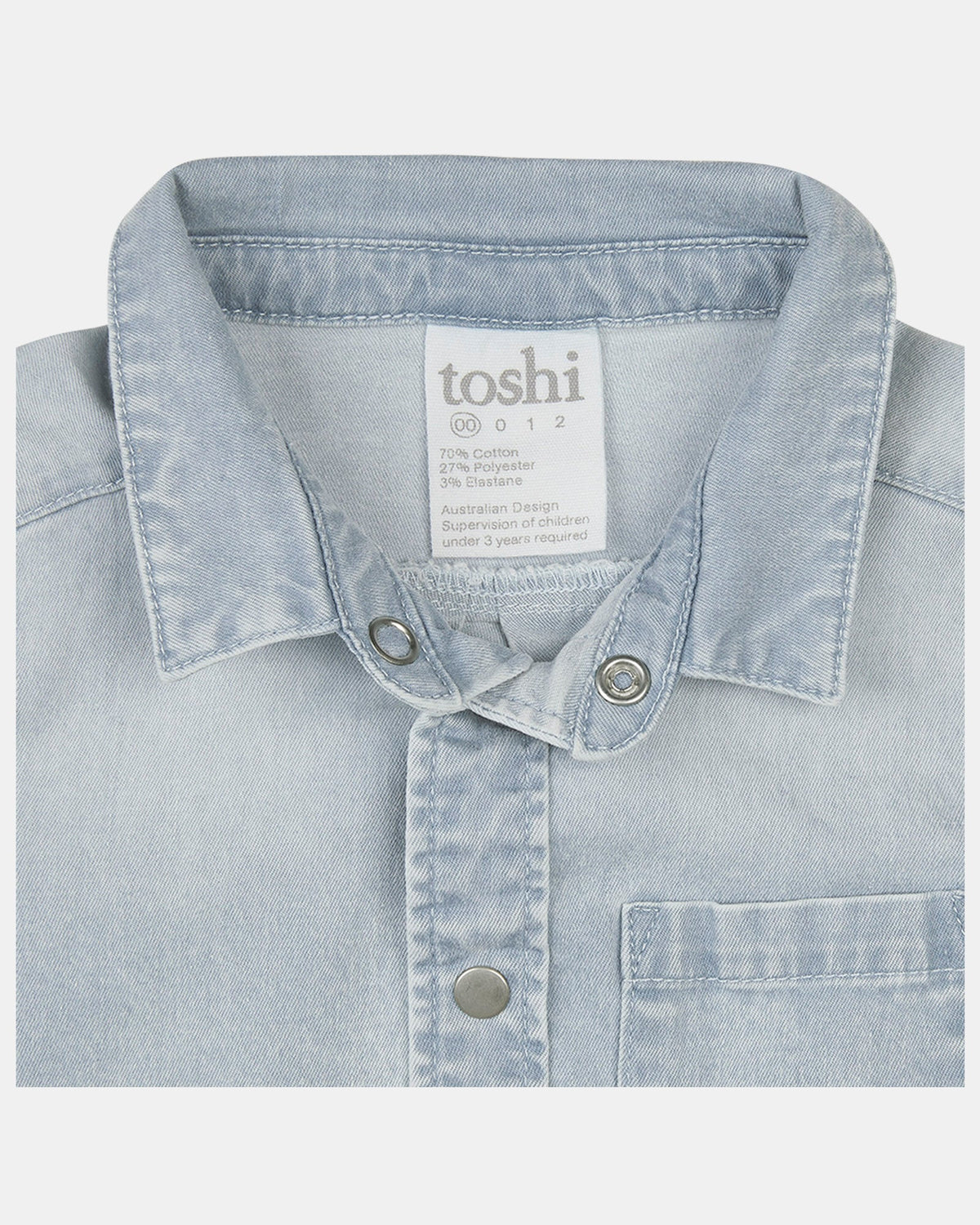 Close-up of the collar, press studs, chest pocket and the composition label reading 70% cotton, 27% polyester, 3% elastane