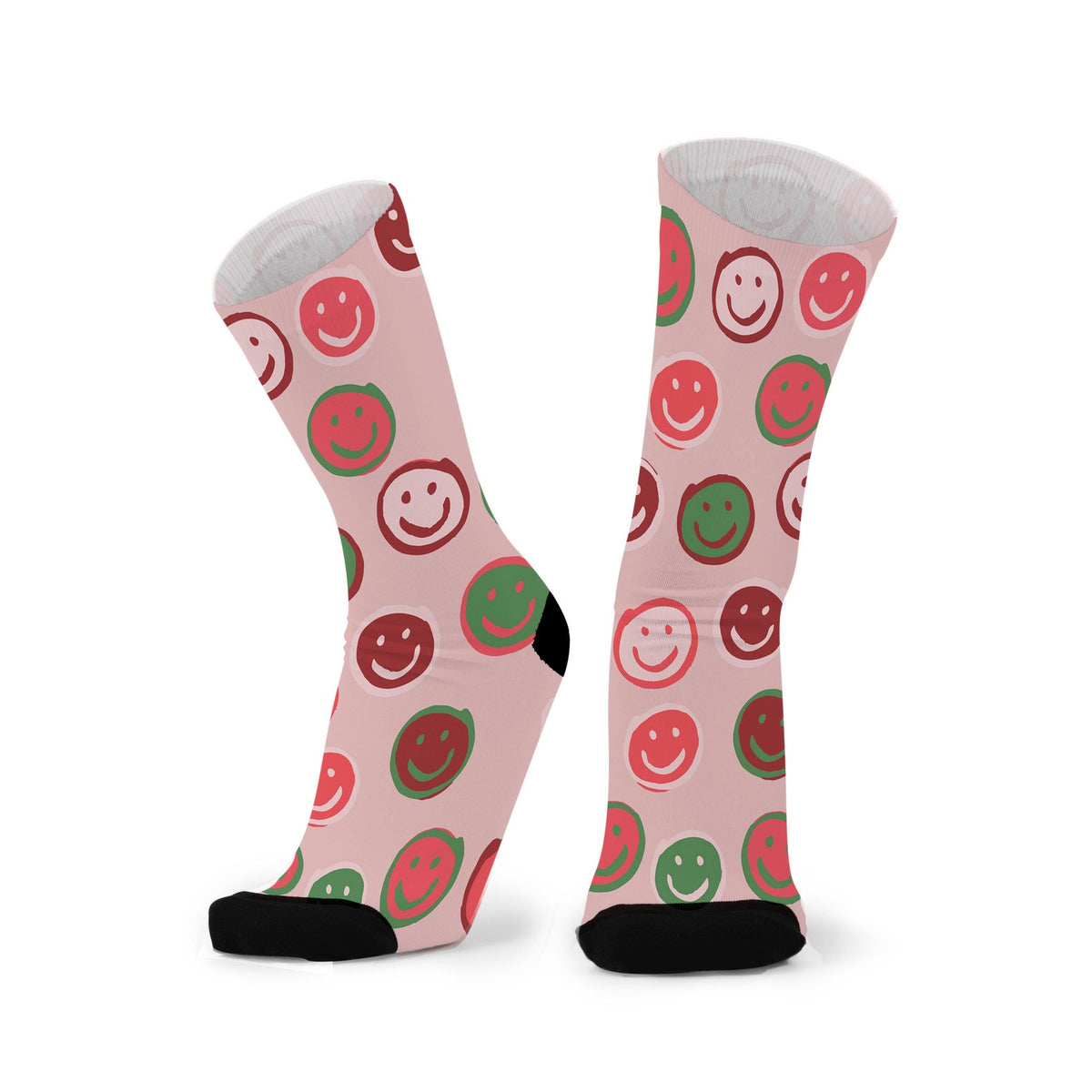 The pair of Happy Toes socks standing, pink with red and green smiling faces and black heels and toes.